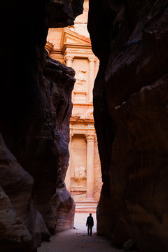 A traveller gazes at the Treasury at the ancient historic site of Petra, Jordan
