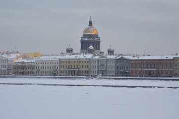 Winter view on the Neva river and the embankment with St. Isaac's Cathedral in St. Petersburg