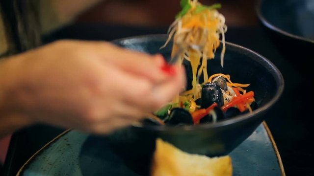 Eating dish with mussels asian restaurant service
