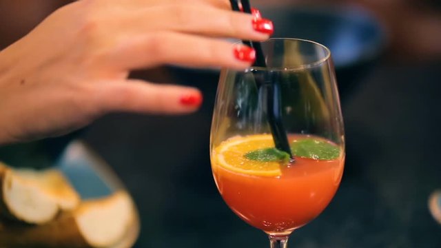 young woman in cafe enjoying fresh juice coctail