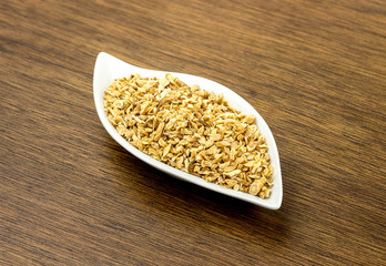 Macro of Astralagus roots in plate against wooden background