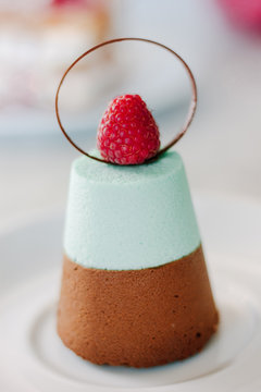Delicious layered dessert cake with chocolate, souffle and raspberry.