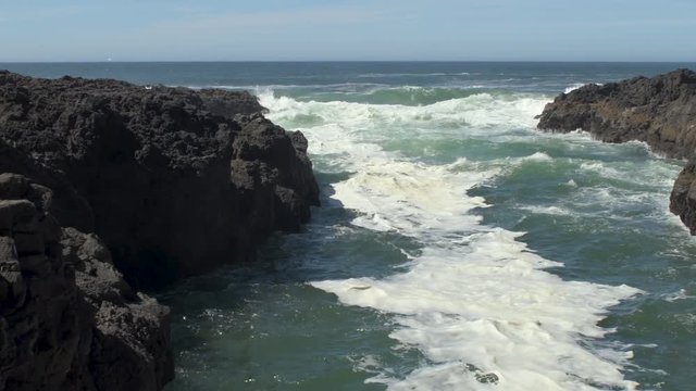 Ocean waves flowing crashing in the Devil's Churn inlet on the central Oregon Coast in the Cape Perpetua Scenic Area