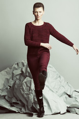 Art fashion, pret-a-porter concept. Full length portrait of androgynous model with short hair...