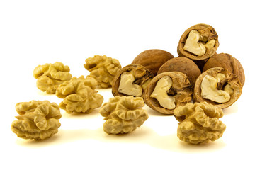 light yellow walnut core close-up with peel and leaves stacked in a isolate composition on a white background