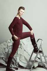 Art fashion, pret-a-porter concept. Full length portrait of androgynous model with short hair...