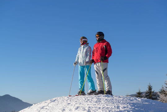 Skiers watching winter mountains