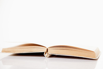 Open book on white background as a symbol of literature and knowledge.