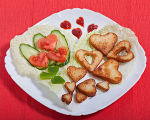 French fries and vegetables cut into the heart. Valentine's Day
