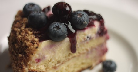 Close up of rotating homemade professional quality vanilla cake with fruit berries compote and fresh blueberries
