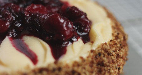 Adding cream and fruit to cake