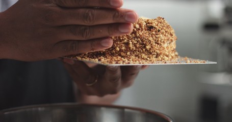 Adding cream and fruit to cake