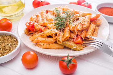 delicious penne pasta on wood white table