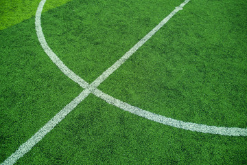 Obraz premium Green soccer field with white circle line, Flat lay