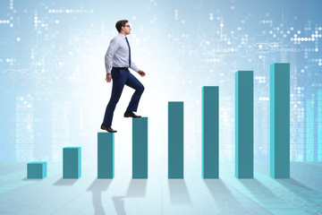 Businessman going up the bar chart in growth concept
