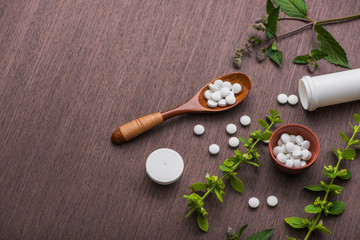 Fototapeta na wymiar Organic medical pills with herbal plant