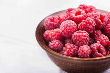 Red fresh raspberry in bowl