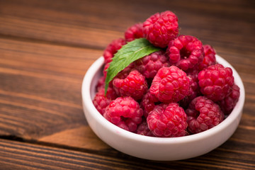 Red fresh raspberry in bowl