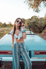 Girl posing on a background cabriolet