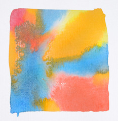 Handmade watercolour wallpaper, in wet on wet technique, with vivid red, yellow, orange and blue paint merging into each other in a square area, on white paper.