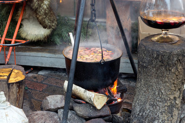Hot gluhwein bowl on fire at a christmas fair, Riga, Latvia