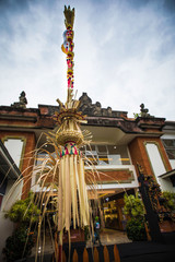 Traditional Bali Penjor, bamboo pole with decoration on Balinese people house in Bali