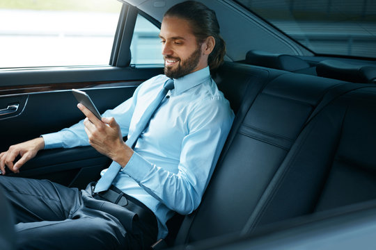 Young Successful Man Working On Phone Sitting In Car. - Powered by Adobe