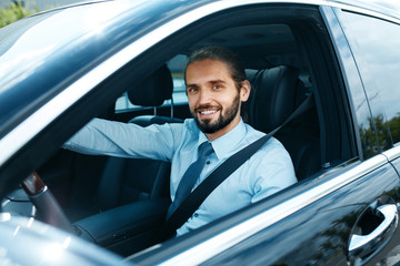 Fototapeta na wymiar Man Driving Car. Portrait Of Smiling Male Driving Car