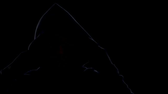 Dangerous anonymous male in night darkness, scary terrorist preparing for crime