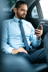 Young Successful Man Working On Phone Sitting In Car.