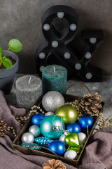 Christmas decorations, balls, candles. Blue, white and gray.