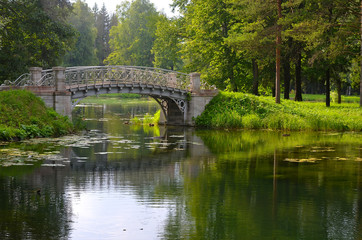 Fototapeta na wymiar Metal bridge in Gatchina park near St. Petersburg, Russia