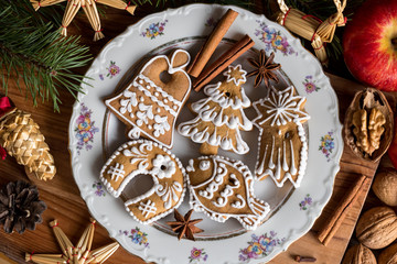 Decorated Christmas gingerbread cookies on a white plate