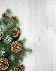 Christmas and New Year's composition. The pine cones, spruce branches on a wooden white background