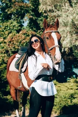 Foto op Canvas fashionable brunette with a racehorse © Mikhaylovskiy 