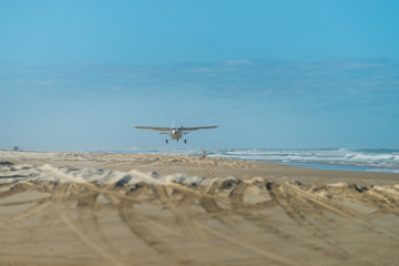 Fototapeta na wymiar Plane landing on beach