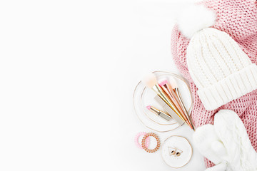 Warm winter clothes and Christmas decor. Arrangement in pastel pink colors.