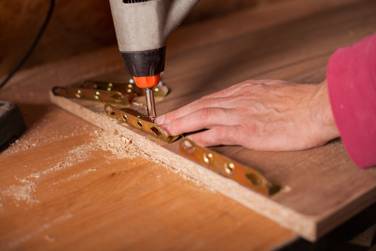 Carpenter work on wood plank in workshop