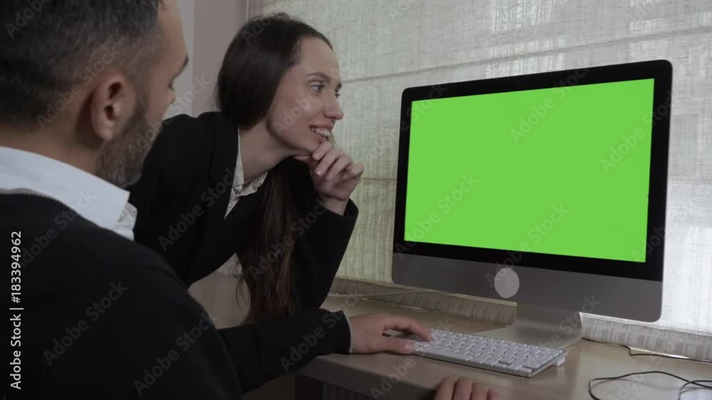 Poster colleagues looking on green screen computer discussing project. young woman standing near working pl