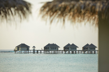 Water bungalows in hotel on Maldives. Villas on Indian ocean at luxury spa resort.