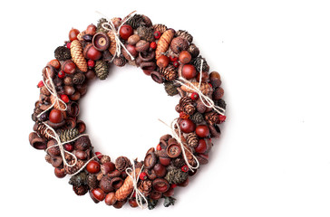 Christmas wreath wreath of acorns and cones and dog rose on the wooden background.Copy space.Christmas background