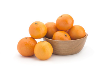 Orange tangerines on a wooden plate on a white background
