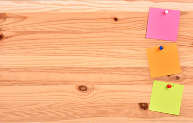 Colorful notes on a wooden board.Texture with notes.A collection of papers for notes.A set of office stickers.