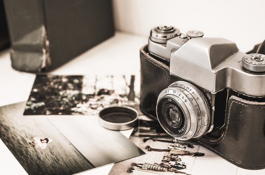 Vintage Photo Camera In Brown Retro Leather Case Holder On Wooden Background With Instagram Retro Filter Effect