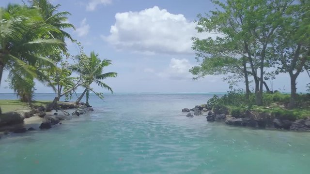 track and zoom in from island to coral reef of tropical atoll lagoon, Tahiti, French Polynesia
