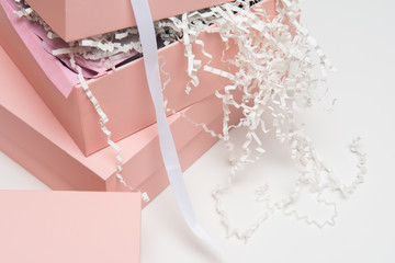 Christmas gift wrapped in pink boxes and ribbon on white