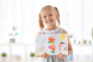 Cute girl with picture on blurred background