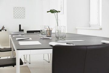 Modern office interior with large table and chairs