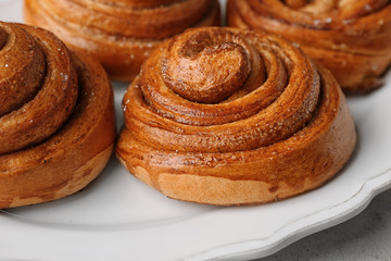 Plate with sweet cinnamon rolls, closeup