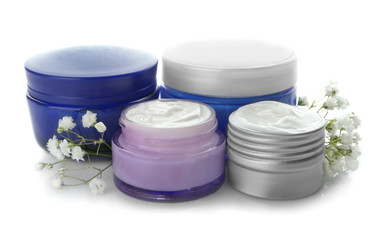 Jars with natural cream on white background